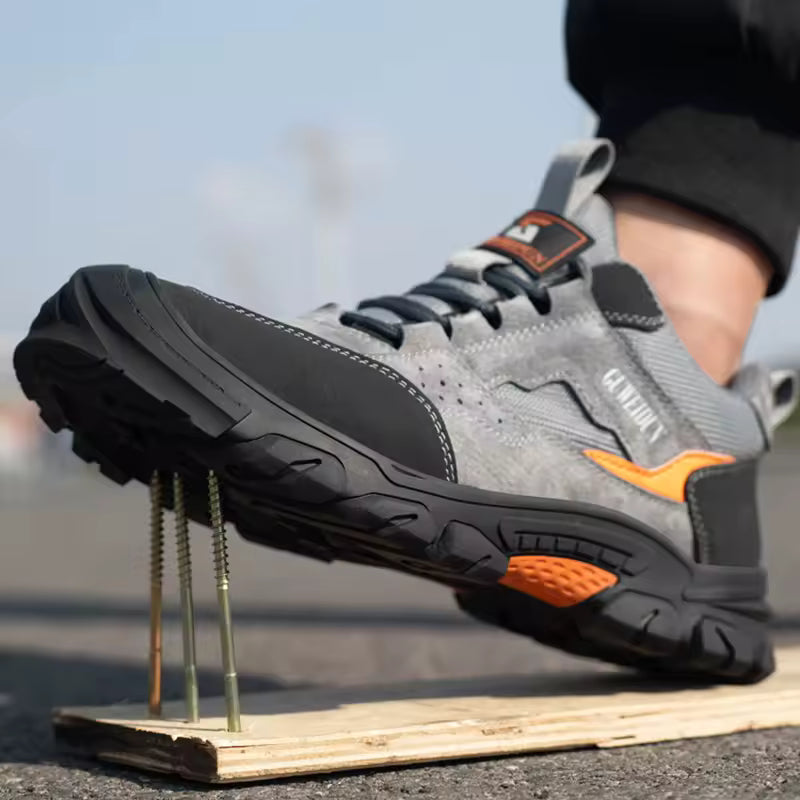 Gray and black work boot with orange accents on a stand outdoors